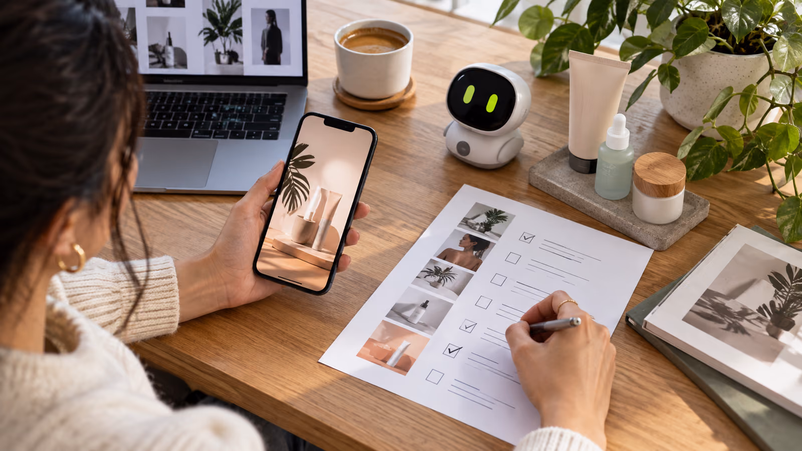 Creator checking a vertical product ad and landing-page brief beside a small expressive pocket AI companion