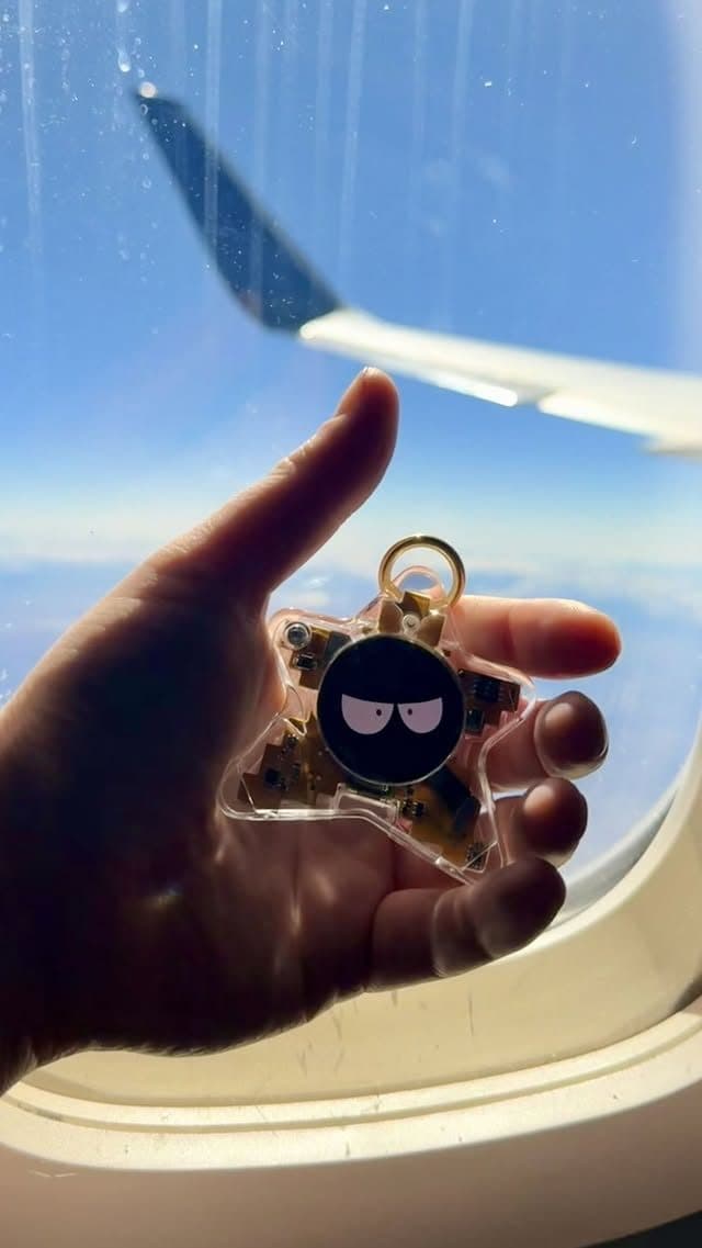 Oneira working prototype held up to an airplane window mid-flight — unretouched photo