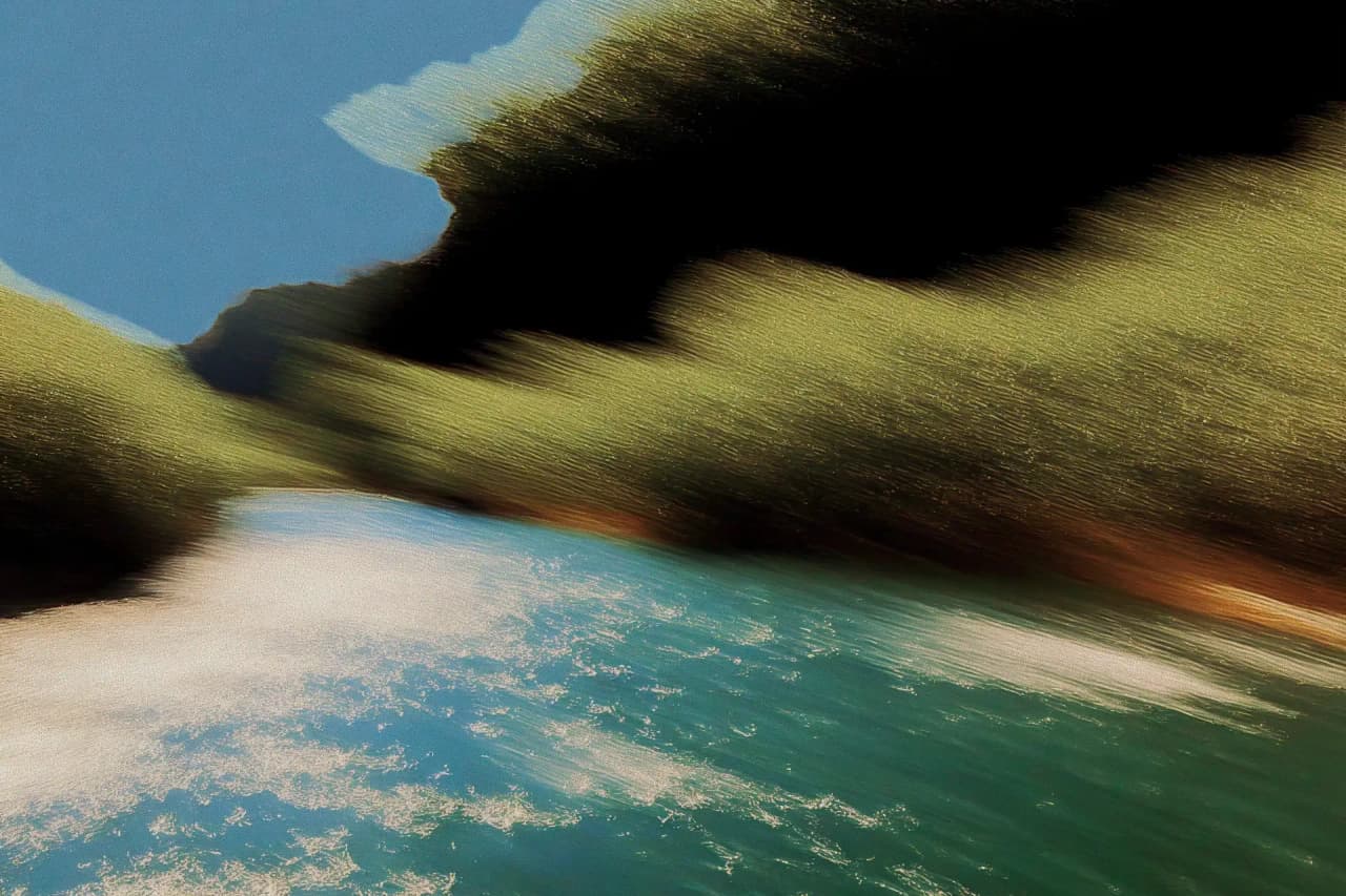 Textured turquoise water between dark rolling hills
